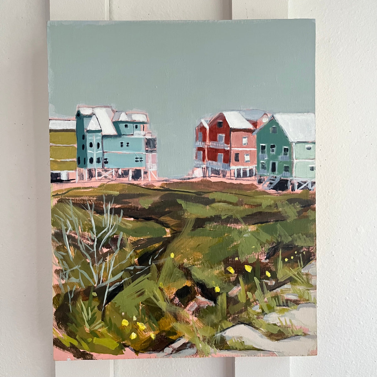 Fort Morgan — pastel beach houses beyond coastal grasses under a muted blue-green sky. Painting by Maggie Stickney.
