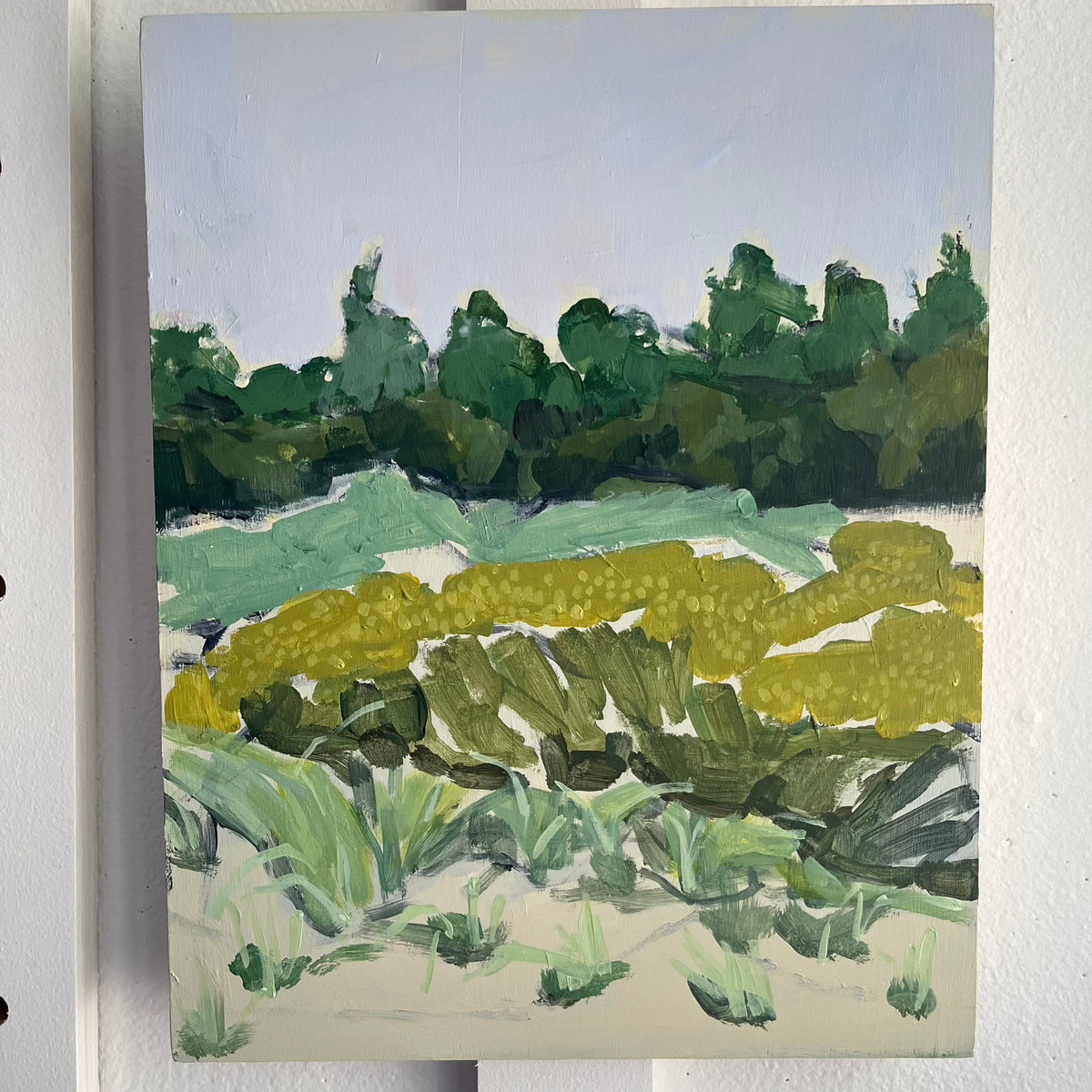 Gulf State Park no 8 — layered green marsh grasses and trees beneath a pale sky. Painting by Maggie Stickney.