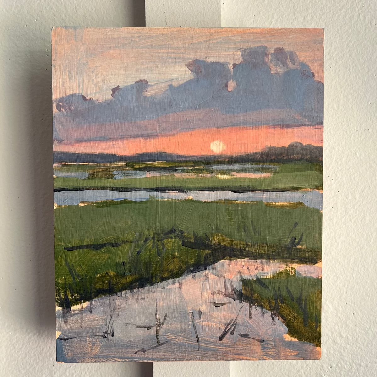 Mini Marsh Sunset — a low sun over marsh channels reflecting a pink and gray sunset. Painting by Maggie Stickney.