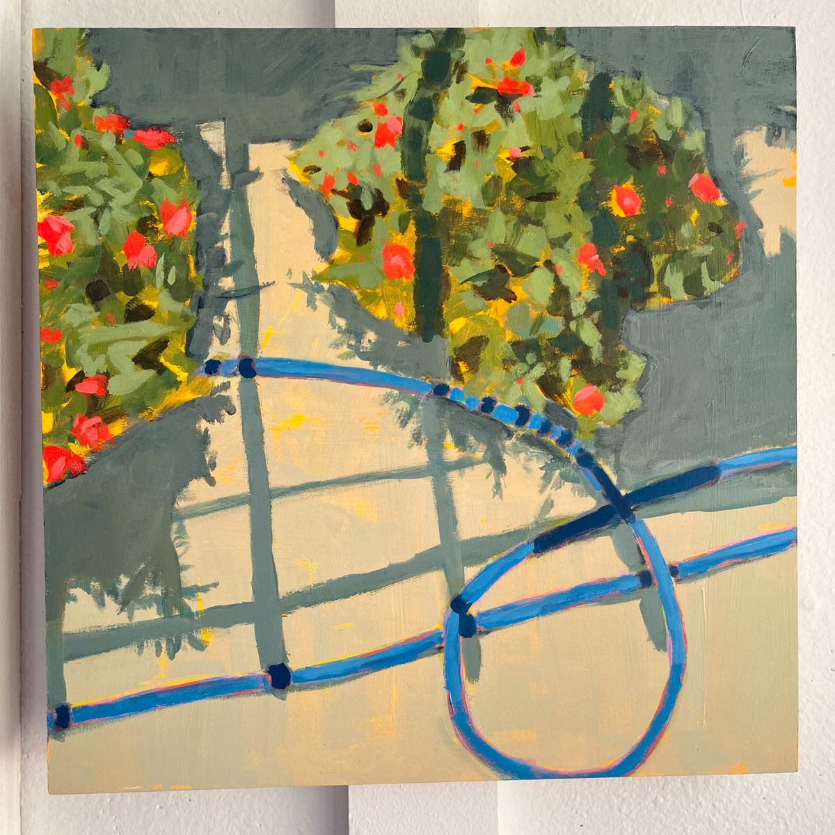 Sun Patients — flowering plants and a blue garden hose casting shadows on a sunny wall. Painting by Maggie Stickney.