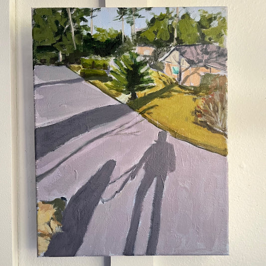 Morning Walk no 3 (winter) — long shadows of a person and dog on a sunlit neighborhood road. Painting by Maggie Stickney.
